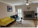 Comfortable living room with stone fireplace and yellow and green colored couches at 2860 Pine St, Duluth, GA 30096