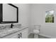 Bright bathroom offers granite countertops, gray tile floors, and modern black fixtures at 43 George Lemon Dr, Mcdonough, GA 30253