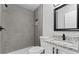 Modern bathroom features tiled walls, granite countertops, white vanity, and modern fixtures at 43 George Lemon Dr, Mcdonough, GA 30253