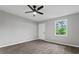 A spacious bedroom with hardwood floors, ceiling fan, closet, and a bright window at 43 George Lemon Dr, Mcdonough, GA 30253
