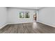 Bright bedroom with wood floors and a large window offering natural light and outdoor views at 43 George Lemon Dr, Mcdonough, GA 30253