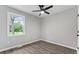 Bright bedroom features hardwood floors, neutral walls, a ceiling fan, and a window at 43 George Lemon Dr, Mcdonough, GA 30253