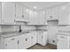 Bright kitchen features white cabinets, granite countertops and modern appliances at 43 George Lemon Dr, Mcdonough, GA 30253