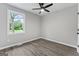 Bright bedroom with hardwood floors, a ceiling fan, and a view of the outdoors at 43 George W. Lemon Dr, Mcdonough, GA 30253