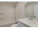 Well-lit bathroom with tub/shower combo, and a bright white vanity at 4521 Twinberry Dr, Powder Springs, GA 30127