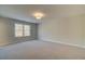Neutral bedroom features plush carpet and a window with a backyard view at 4521 Twinberry Dr, Powder Springs, GA 30127