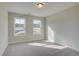 Bright bedroom with two large windows and neutral carpeting, offering a serene retreat at 4521 Twinberry Dr, Powder Springs, GA 30127