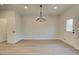An open dining area with a modern chandelier and neutral walls creates an inviting atmosphere at 4521 Twinberry Dr, Powder Springs, GA 30127
