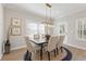 Bright dining room features a modern light fixture and seating for six, perfect for Gathering meals at 4521 Twinberry Dr, Powder Springs, GA 30127