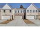 Charming townhome with a brick facade, attached garages, and well-maintained landscaping at 4521 Twinberry Dr, Powder Springs, GA 30127