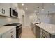 Modern kitchen featuring white cabinets, stainless steel appliances, and a large island with a sink at 4521 Twinberry Dr, Powder Springs, GA 30127
