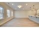 Spacious living room area with modern lighting and neutral paint colors offers buyers a blank slate at 4521 Twinberry Dr, Powder Springs, GA 30127