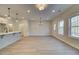 Open-concept living space with a modern kitchen, dining area, and large windows for natural light at 4521 Twinberry Dr, Powder Springs, GA 30127