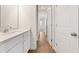 Bathroom featuring white cabinets, sink, and wood-look flooring at 809 Dobby Way (Lot 94), Mcdonough, GA 30252