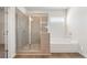 Bathroom featuring a glass enclosed shower, soaking tub, and tile surround at 809 Dobby Way (Lot 94), Mcdonough, GA 30252