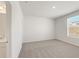 Serene bedroom featuring neutral carpet, a large window, and ensuite bath at 809 Dobby Way (Lot 94), Mcdonough, GA 30252