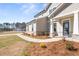 Welcoming home with a stone-accented entrance, covered porch and landscaped walkway at 809 Dobby Way (Lot 94), Mcdonough, GA 30252
