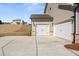 Spacious two-car garage with modern doors and an expansive concrete driveway at 809 Dobby Way (Lot 94), Mcdonough, GA 30252