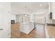 Bright kitchen with white cabinets, island, stainless appliances, and granite counters at 809 Dobby Way (Lot 94), Mcdonough, GA 30252
