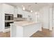 Modern kitchen featuring white cabinets, granite counters, and stainless appliances at 809 Dobby Way (Lot 94), Mcdonough, GA 30252