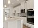 Elegant kitchen featuring granite countertops, stainless steel appliances, and bright lighting at 809 Dobby Way (Lot 94), Mcdonough, GA 30252