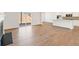 Open-concept living area features wood floors and an adjacent kitchen at 809 Dobby Way (Lot 94), Mcdonough, GA 30252