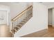 Bright staircase with hardwood treads, iron railings, and natural light at 809 Dobby Way (Lot 94), Mcdonough, GA 30252