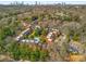 Wonderful aerial view of brick townhomes with mature trees and a shared pool at 19 Lullwater Ne Pl, Atlanta, GA 30307