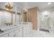 Elegant bathroom featuring marble countertops, dual sinks, and a glass enclosed shower at 19 Lullwater Ne Pl, Atlanta, GA 30307