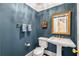 Stylish powder room featuring a pedestal sink, gold mirror, and elegant fixtures at 19 Lullwater Ne Pl, Atlanta, GA 30307