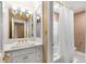 Well-lit bathroom with marble countertop, white vanity, gold hardware, and tile flooring at 19 Lullwater Ne Pl, Atlanta, GA 30307
