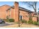 Brick townhome with classic architecture, chimney, black shutters, and tidy landscaping at 19 Lullwater Ne Pl, Atlanta, GA 30307
