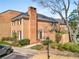 Charming brick townhome featuring a well-maintained yard, chimney, and inviting entrance at 19 Lullwater Ne Pl, Atlanta, GA 30307