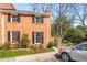 Side view of a brick townhome featuring dark shutters and a well-manicured landscape at 19 Lullwater Ne Pl, Atlanta, GA 30307