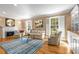 Bright living room featuring hardwood floors, a fireplace, and built-in shelving at 19 Lullwater Ne Pl, Atlanta, GA 30307