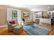 Bright living room with hardwood floors, built-in shelving, and large windows with shutters at 19 Lullwater Ne Pl, Atlanta, GA 30307