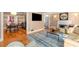 Inviting living room with hardwood floors, fireplace, and an open doorway leading to the dining room at 19 Lullwater Ne Pl, Atlanta, GA 30307