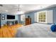 Bright main bedroom featuring hardwood floors, plantation shutters, and ceiling fan at 19 Lullwater Ne Pl, Atlanta, GA 30307