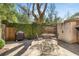 Outdoor patio area with iron table and chairs, surrounded by lush landscaping at 19 Lullwater Ne Pl, Atlanta, GA 30307
