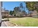 A large backyard, wooden fence, and trees at 613 Lone Oak Dr, Lithonia, GA 30058