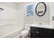 A bathroom has a tub with a shower, toilet, vanity, and oval mirror at 613 Lone Oak Dr, Lithonia, GA 30058