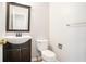 Half bathroom with vanity and mirror, toilet, and brushed nickel hardware at 613 Lone Oak Dr, Lithonia, GA 30058