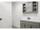 Bathroom sink with gray cabinet, mirror, and shelving at 613 Lone Oak Dr, Lithonia, GA 30058