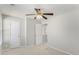 A carpeted bedroom has a ceiling fan and access to another room at 613 Lone Oak Dr, Lithonia, GA 30058