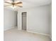 A carpeted bedroom has a ceiling fan, and a door leads to a closet at 613 Lone Oak Dr, Lithonia, GA 30058