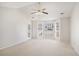 Sunlit bedroom features vaulted ceiling, ceiling fan, carpet, and multiple windows at 613 Lone Oak Dr, Lithonia, GA 30058