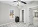 Bright bedroom features a ceiling fan, a storage cabinet, and a spacious closet at 613 Lone Oak Dr, Lithonia, GA 30058