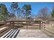 A wooden deck overlooks the backyard with surrounding trees at 613 Lone Oak Dr, Lithonia, GA 30058
