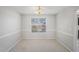 Cozy dining room with neutral carpet, white walls, and a view from the window at 613 Lone Oak Dr, Lithonia, GA 30058