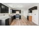 Well-equipped kitchen with dark cabinets, stainless steel appliances, and stylish flooring at 613 Lone Oak Dr, Lithonia, GA 30058